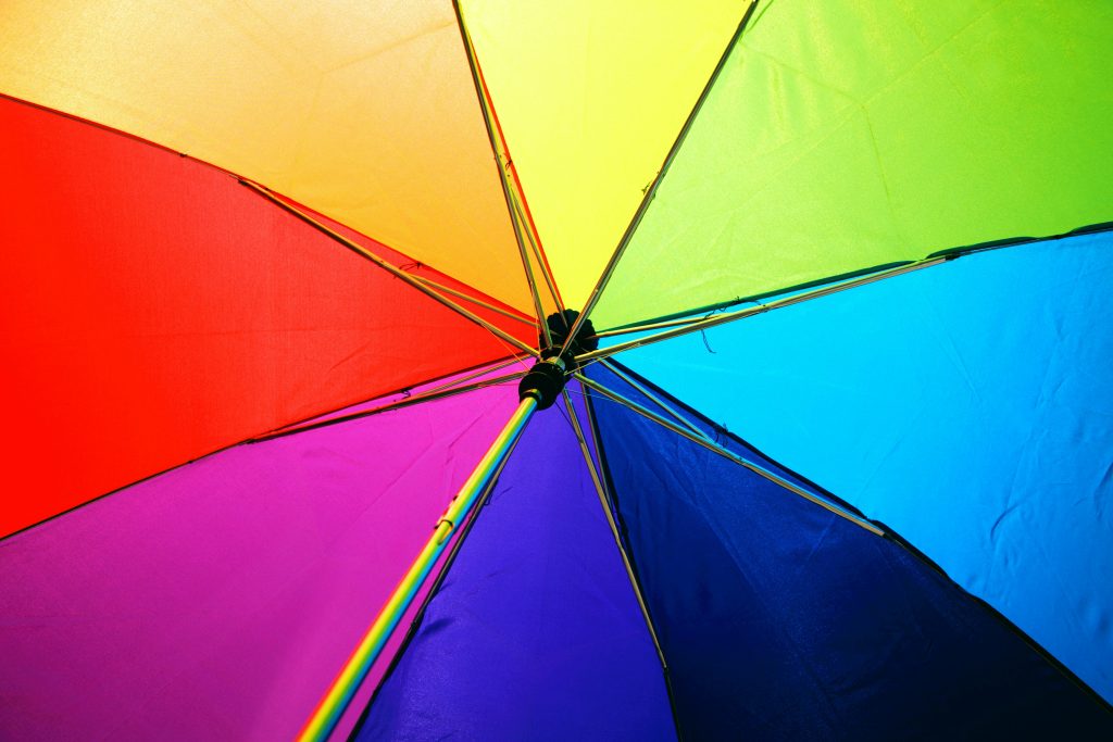 The colorful underside of an umbrella, representing the spectrum of a color wheel.