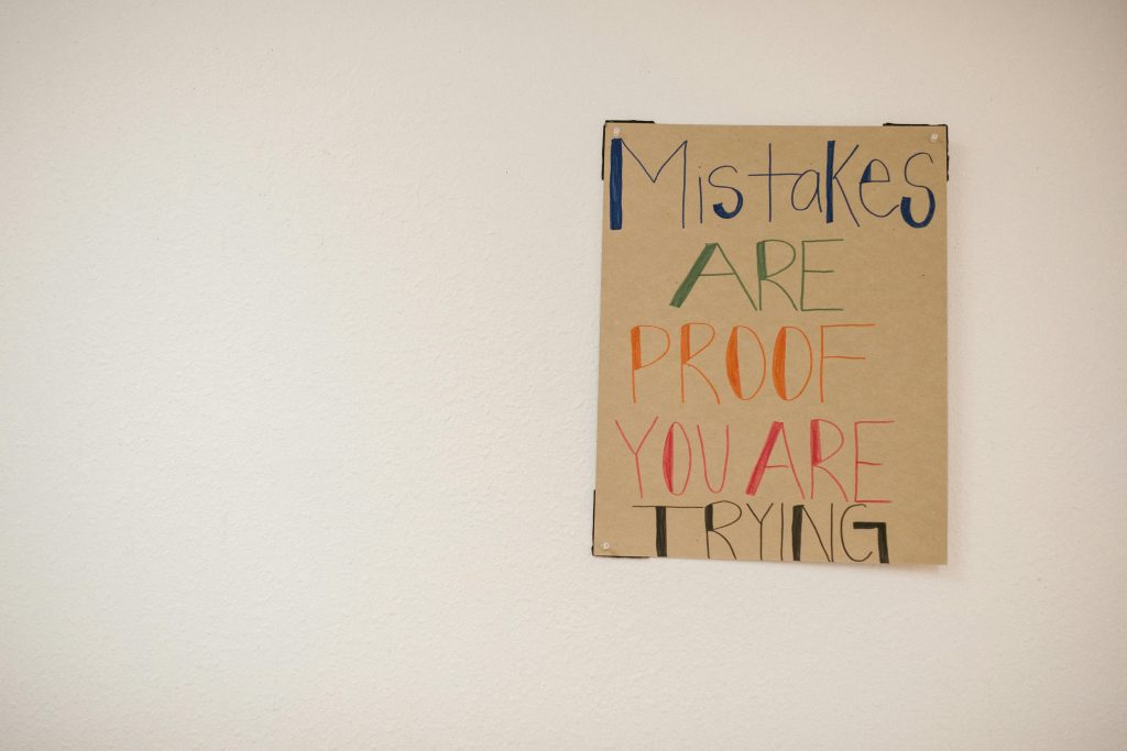 A sign with a message of inspiration on how to keep trying and learn from your mistakes.